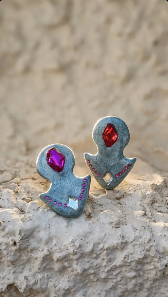 Gem-detail earrings on stone