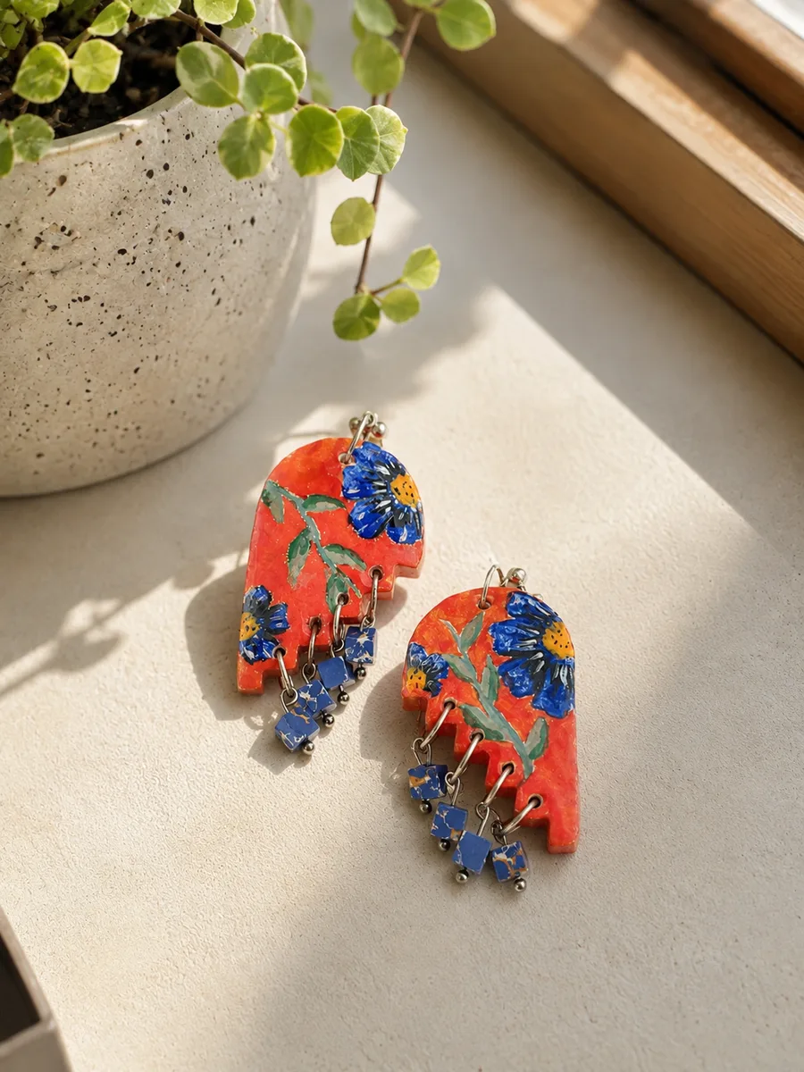 Red floral earrings with blue bead drops